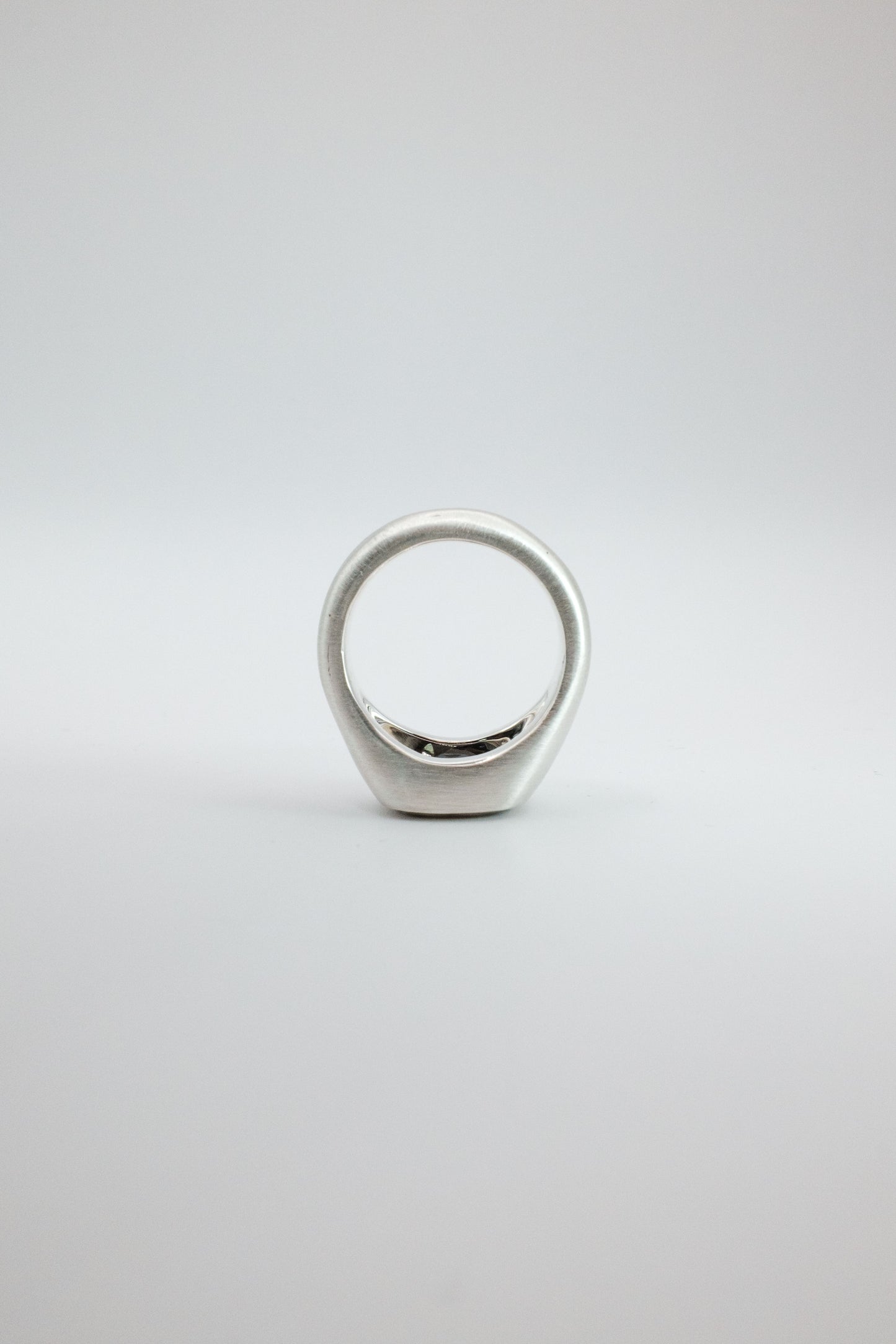 Silver ring on a light gray background