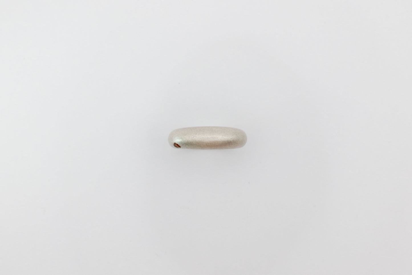 Silver ring on a light gray background