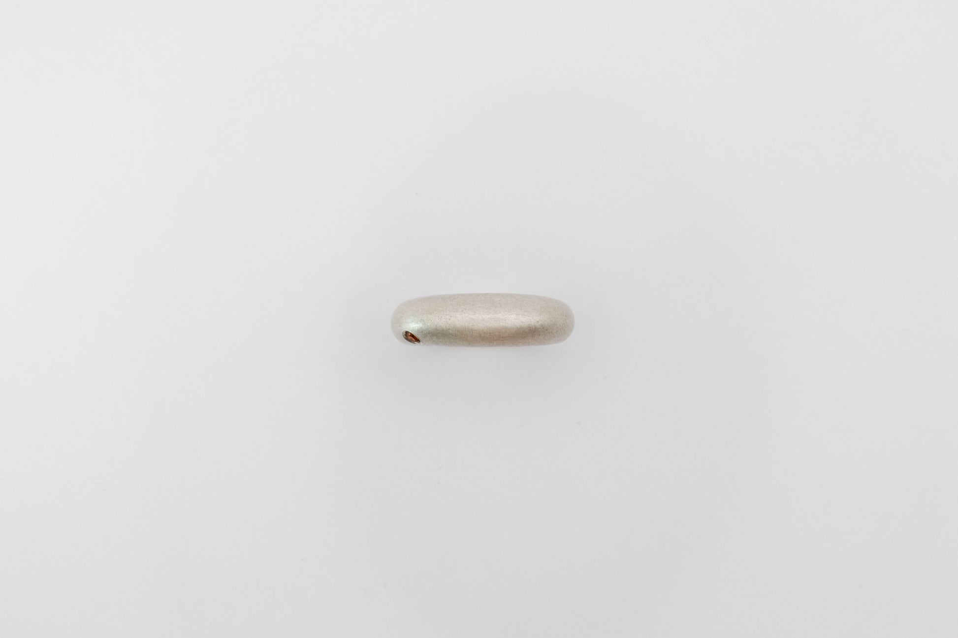 Silver ring on a light gray background