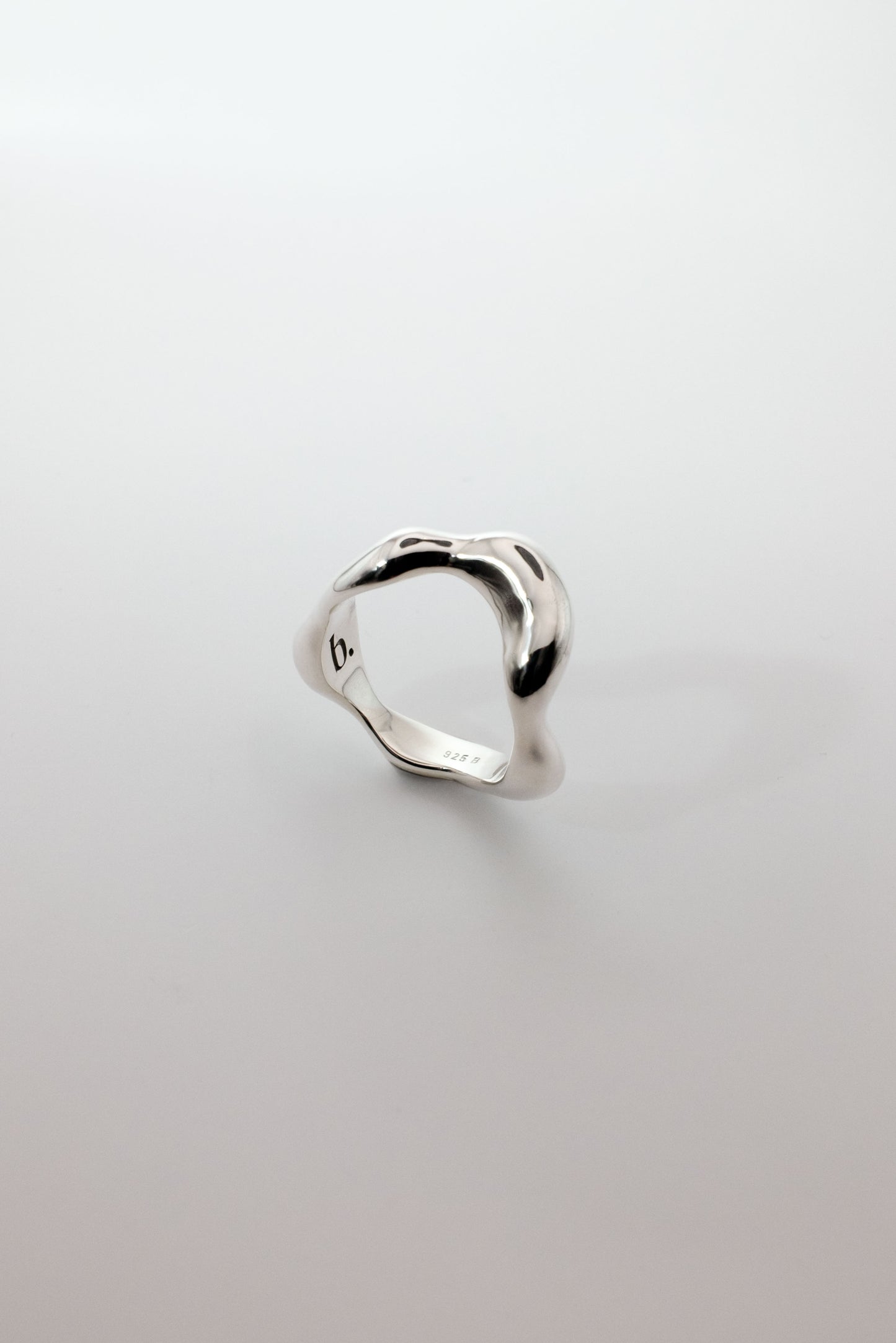 Berhel organic shaped silver ring on a light gray background