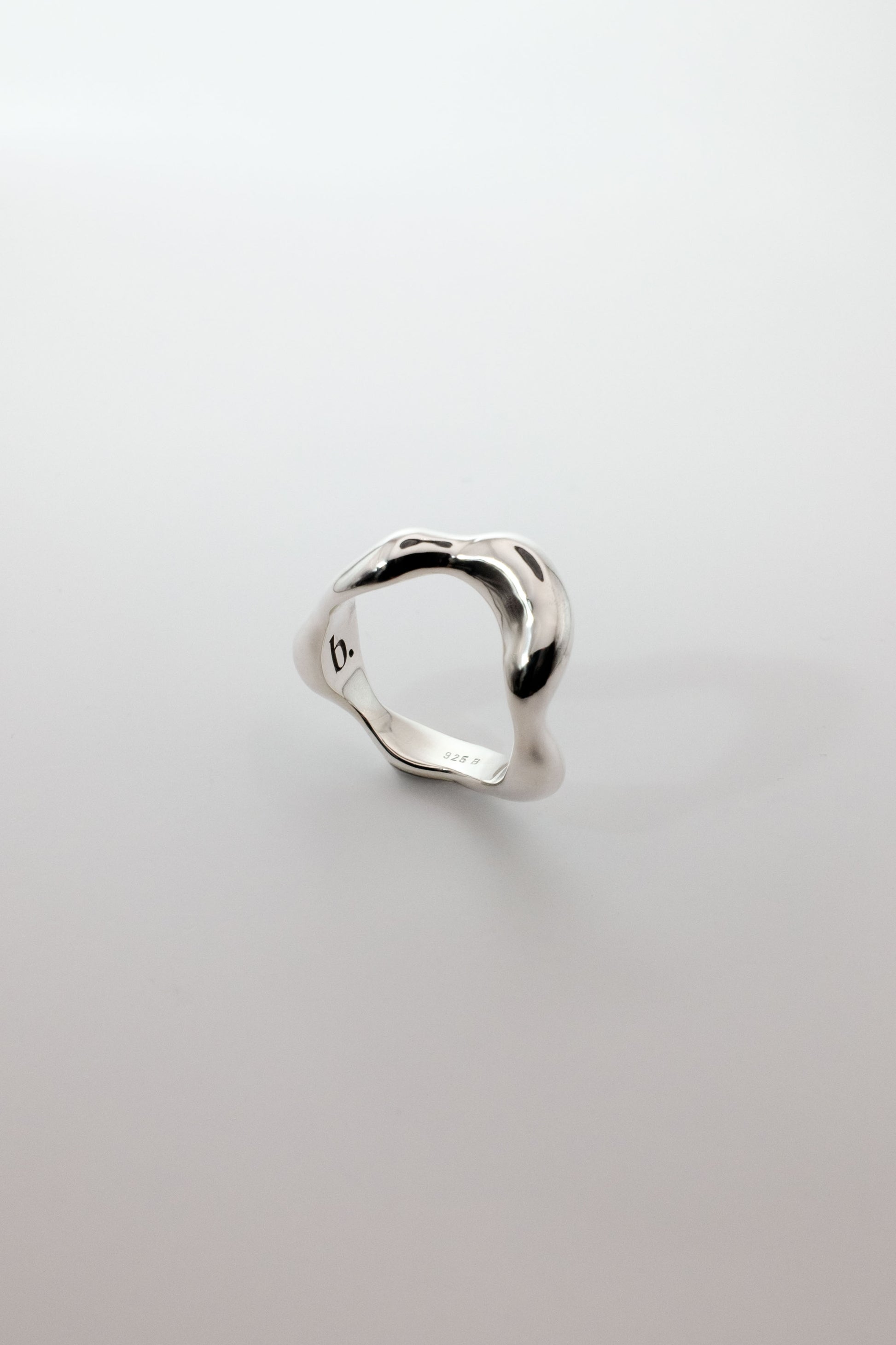 Berhel organic shaped silver ring on a light gray background