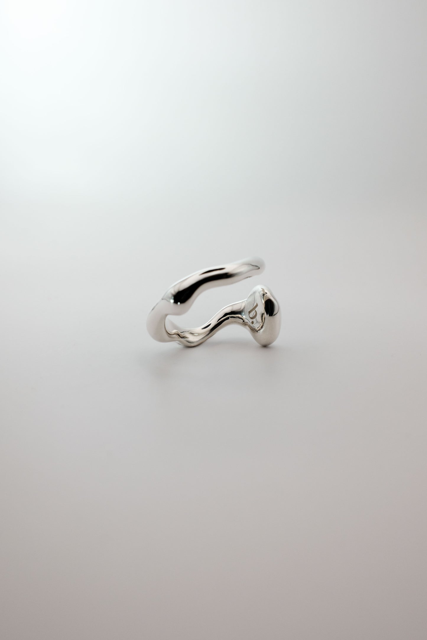 Silver ring on a light gray background