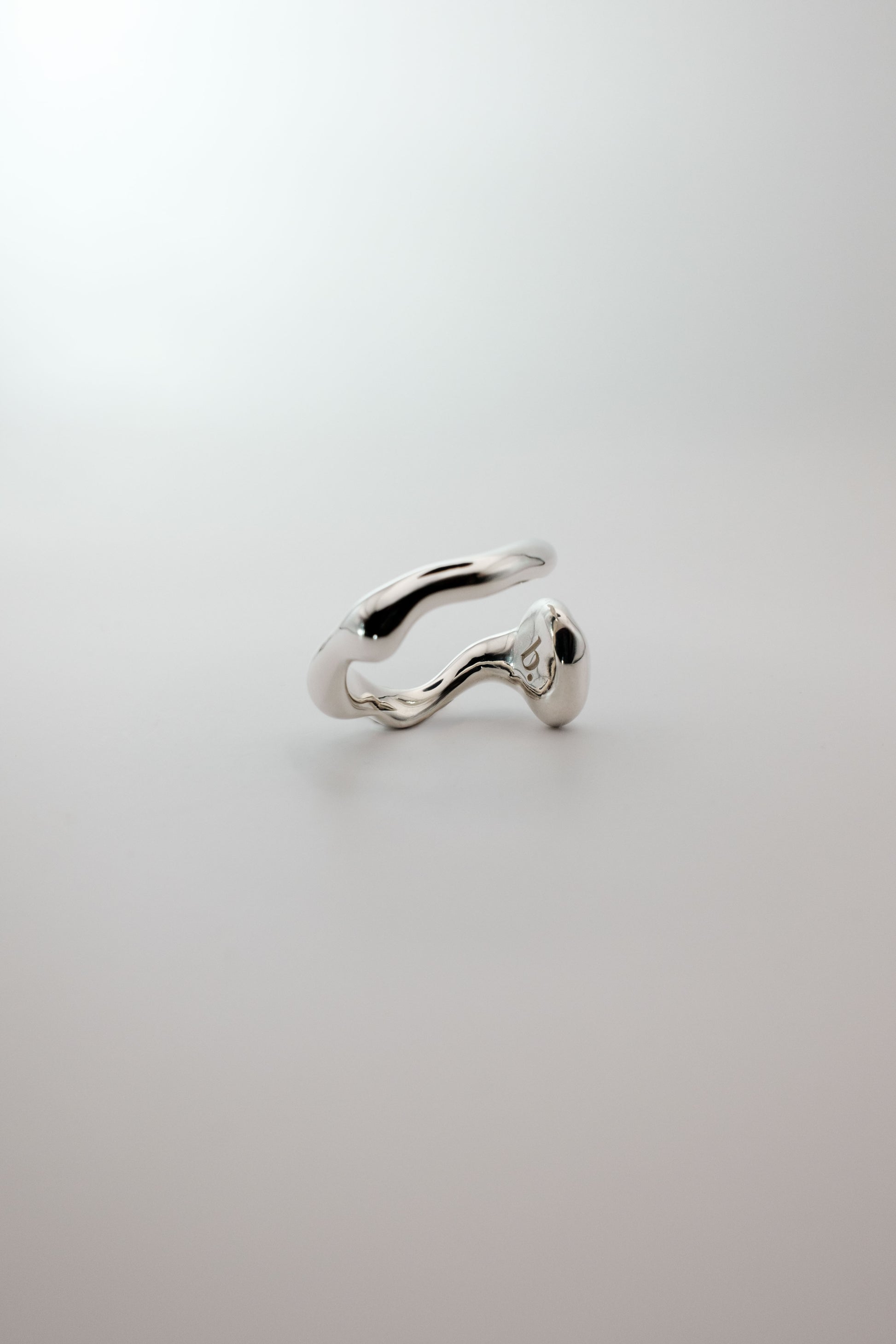 Silver ring on a light gray background