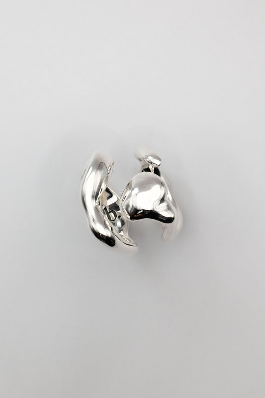 A studio shot of organically shaped silver ring pair