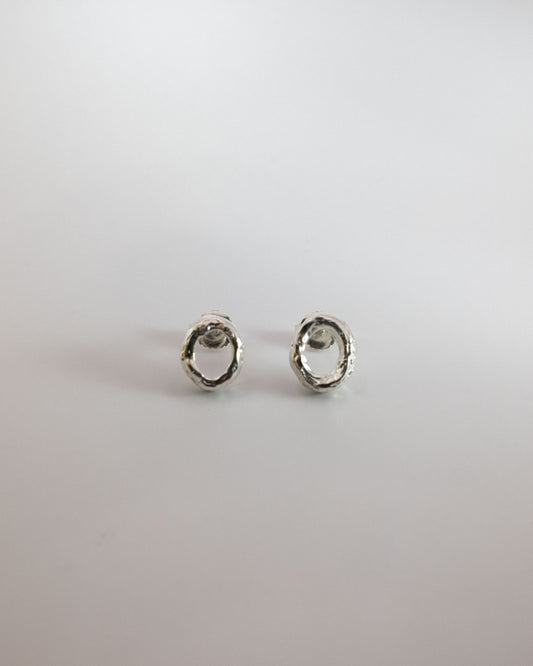 Pair of silver hoop earrings on a light gray background